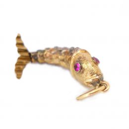 Gold articulated fish pendant, the eyes pink sapphire set