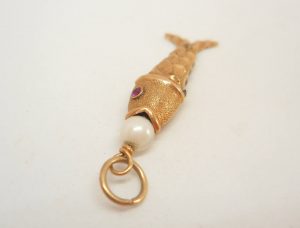 Articulated fish charm with a pearl set to mouth