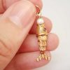Articulated fish charm with a pearl set to mouth