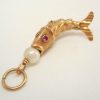 Articulated fish charm with a pearl set to mouth