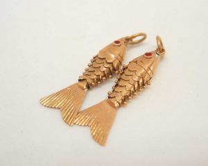 Two very fine 18ct gold baby articulated fish with red eyes