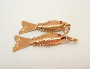 Two very fine 18ct gold baby articulated fish with red eyes