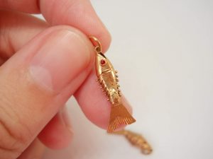 Two very fine 18ct gold baby articulated fish with red eyes