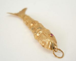Fine vintage gold articulated fish pendant with pink gem set eyes