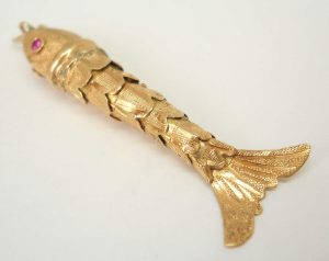Fine vintage gold articulated fish pendant with pink gem set eyes