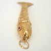 Fine vintage gold articulated fish pendant with pink gem set eyes