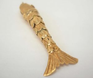 Fine vintage gold articulated fish pendant with pink gem set eyes