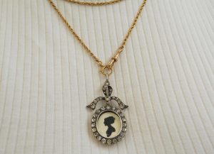 Antique sterling silver and paste bow locket, circa 1900-10