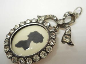 Antique sterling silver and paste bow locket, circa 1900-10