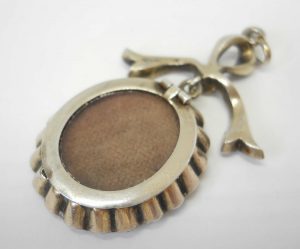Antique sterling silver and paste bow locket, circa 1900-10