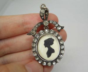 Antique sterling silver and paste bow locket, circa 1900-10