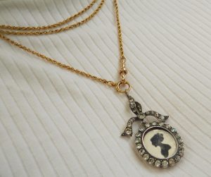 Antique sterling silver and paste bow locket, circa 1900-10