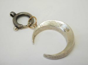 Antique silver paste crescent pendant on a niello bolt ring