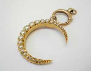 Victorian 15ct gold seed pearl crescent pendant on a 9ct gold bolt ring, both circa 1890