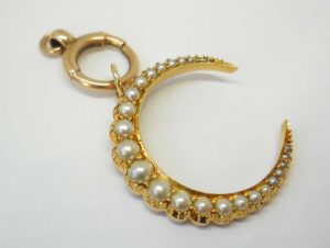 Victorian 15ct gold seed pearl crescent pendant on a 9ct gold bolt ring, both circa 1890