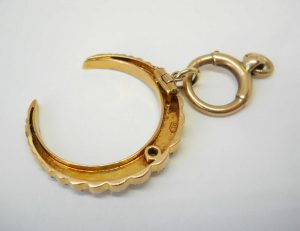 Victorian 15ct gold seed pearl crescent pendant on a 9ct gold bolt ring, both circa 1890