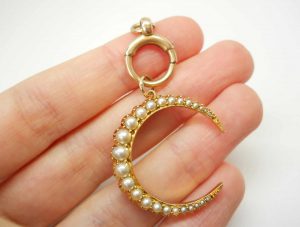 Victorian 15ct gold seed pearl crescent pendant on a 9ct gold bolt ring, both circa 1890