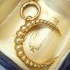 Victorian 15ct gold seed pearl crescent pendant on a 9ct gold bolt ring, both circa 1890