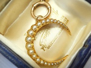 Victorian 15ct gold seed pearl crescent pendant on a 9ct gold bolt ring, both circa 1890