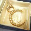 Victorian 15ct gold seed pearl crescent pendant on a 9ct gold bolt ring, both circa 1890