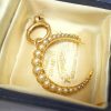 Victorian 15ct gold seed pearl crescent pendant on a 9ct gold bolt ring, both circa 1890