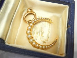 Victorian 15ct gold seed pearl crescent pendant on a 9ct gold bolt ring, both circa 1890