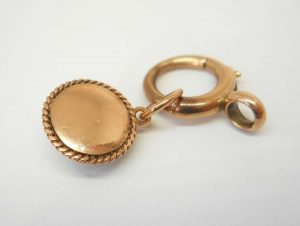 Victorian star set garnet 9ct gold charm on a 9ct gold bolt ring, both circa 1900