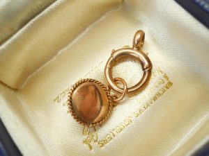 Victorian star set garnet 9ct gold charm on a 9ct gold bolt ring, both circa 1900
